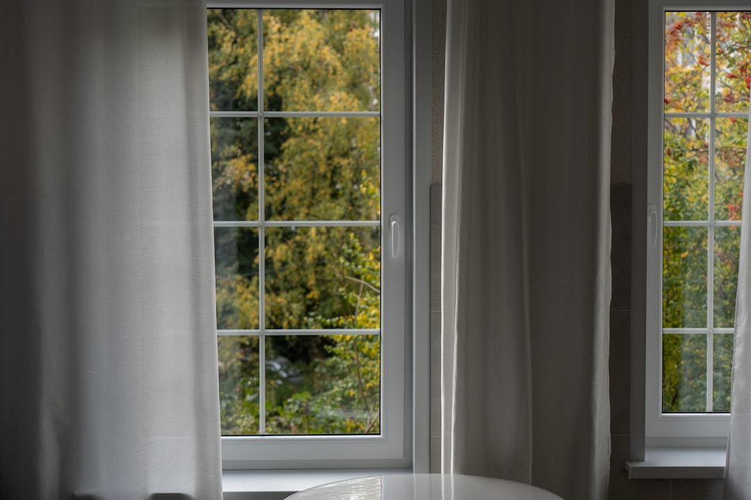 a white table sitting in front of two windows