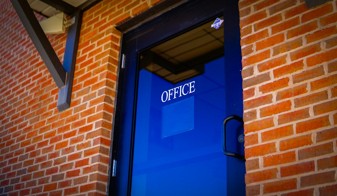 A blue office door on a brick building